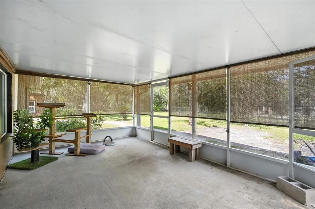 29933 Fullerville Road DeLand, FL 32720 - Photo 27 of 57 a view of an empty room with large windows and table