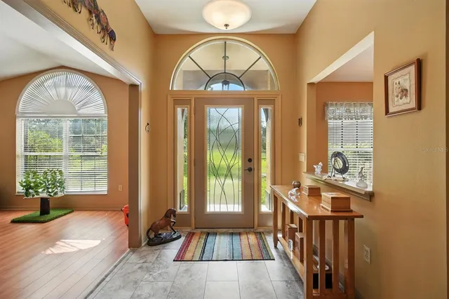 a view of an entryway with wooden floor and a livingroom