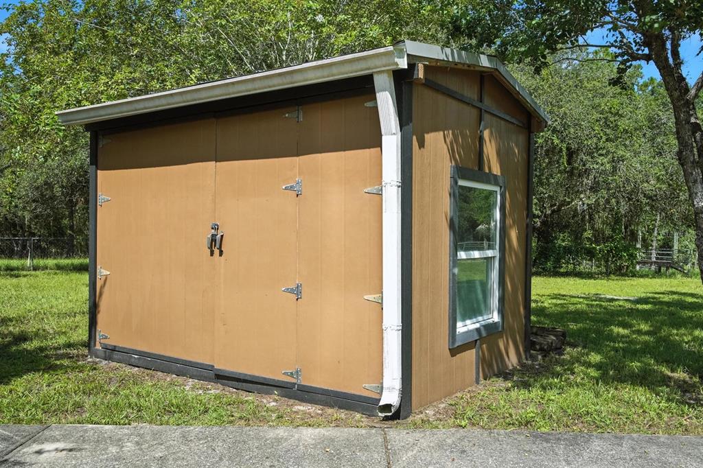 29933 Fullerville Road DeLand, FL 32720 - Photo 41 of 57 a side view of a house with a yard