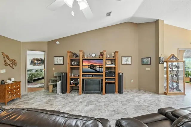 a living room with stainless steel appliances kitchen island furniture and a kitchen view