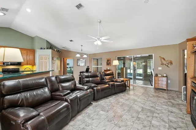 a living room with furniture ceiling fan and a rug