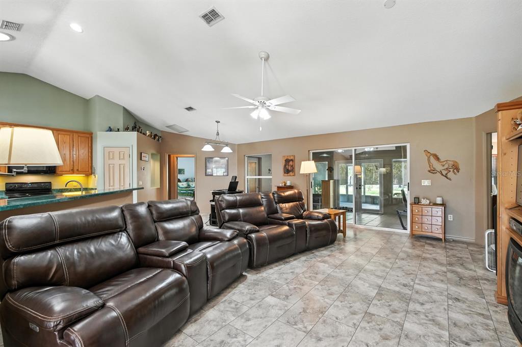 29933 Fullerville Road DeLand, FL 32720 - Photo 9 of 57 a living room with furniture ceiling fan and a rug