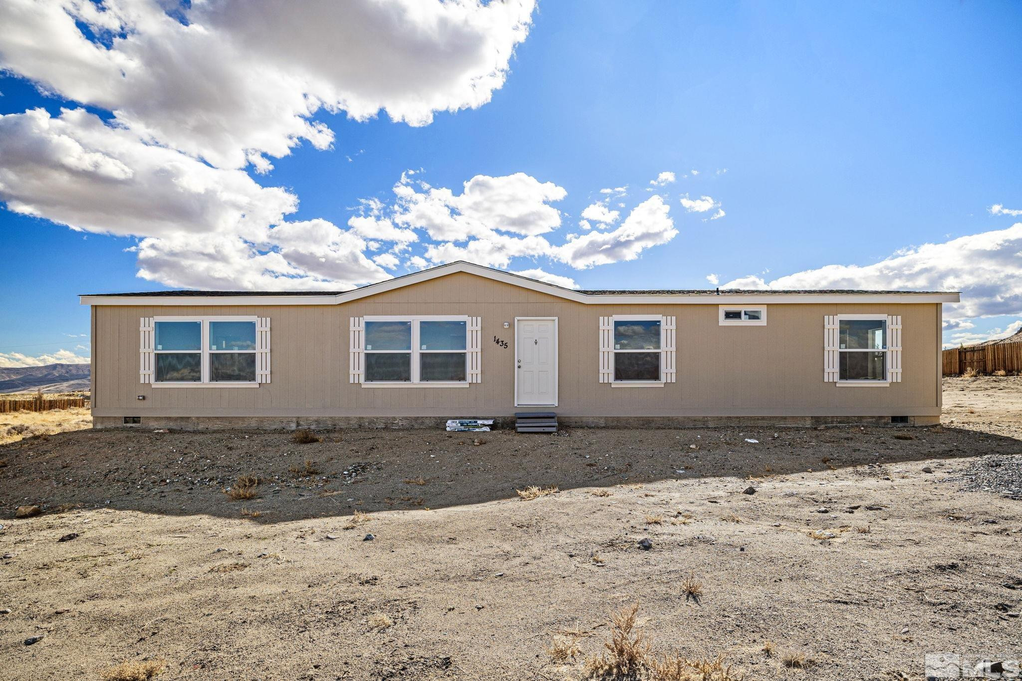 1435 East 8th Street Silver Springs, NV 89429 - Photo 11 of 30 a front view of a house with a yard