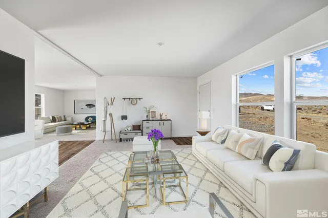 a bedroom with furniture and a large window