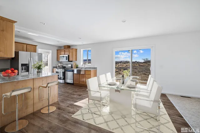 a living room with fireplace furniture and a large window