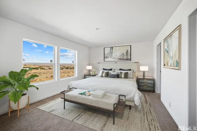 a bedroom with a large bed and a potted plant