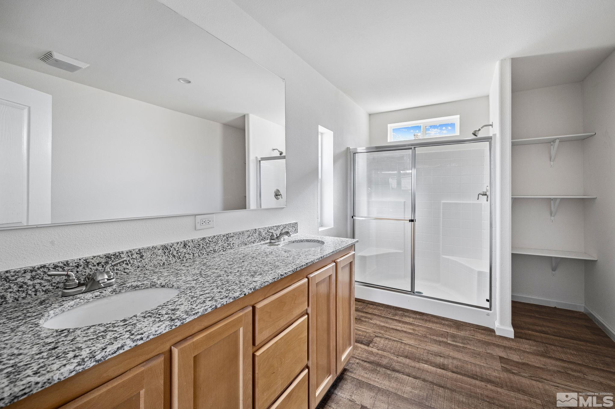 1435 East 8th Street Silver Springs, NV 89429 - Photo 23 of 30 a bathroom with a granite countertop sink and a mirror