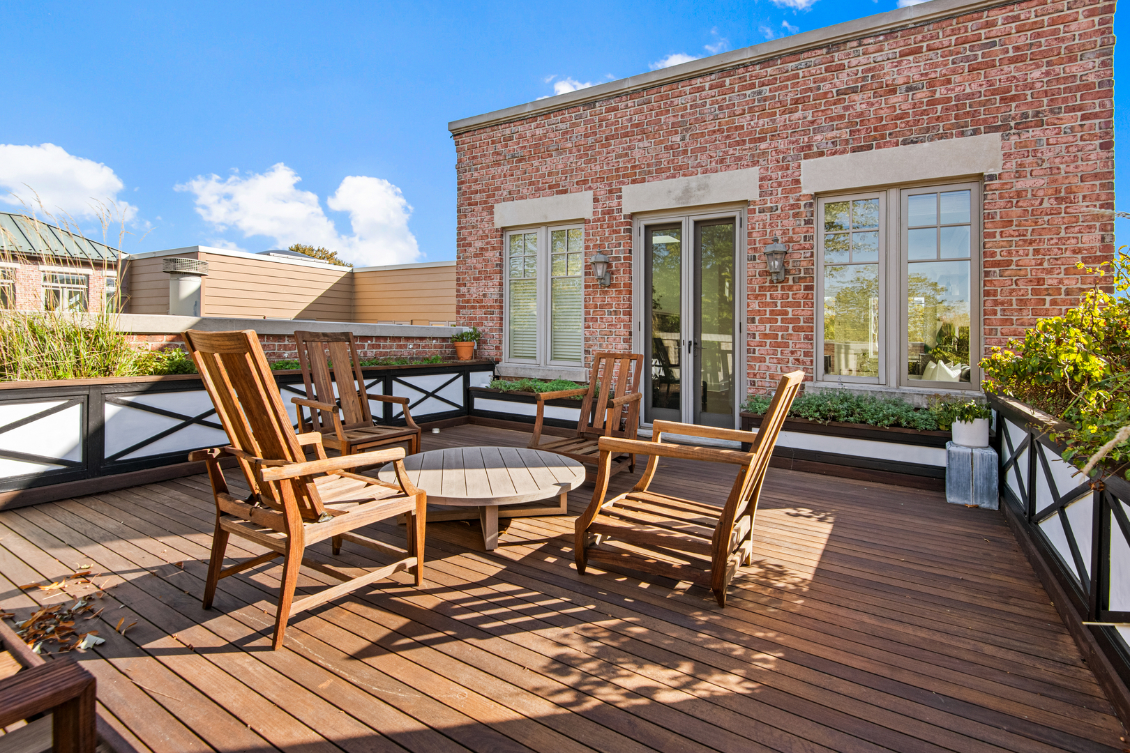 1921 North Mohawk Street Chicago, IL 60614 - Photo 29 of 44 a view of a patio with table and chairs with wooden floor and fence