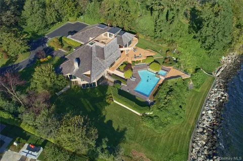 an aerial view of residential house with outdoor space and swimming pool