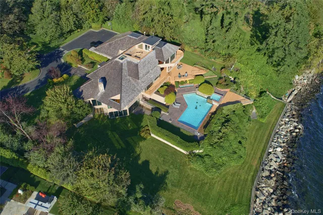 an aerial view of residential house with outdoor space and swimming pool