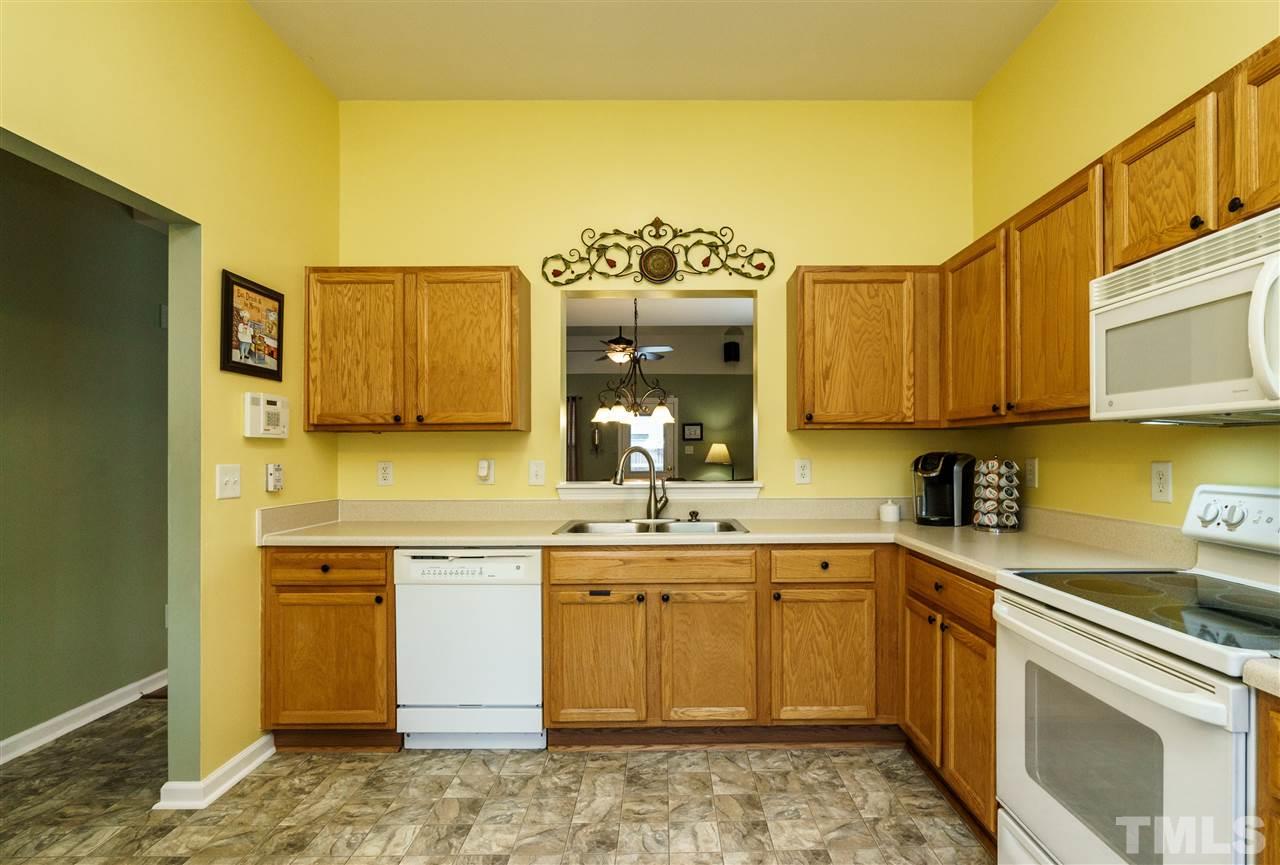 3809 Tyler Bluff Lane Raleigh, NC 27616 - Photo 8 of 25 a kitchen with stainless steel appliances granite countertop a sink and cabinets