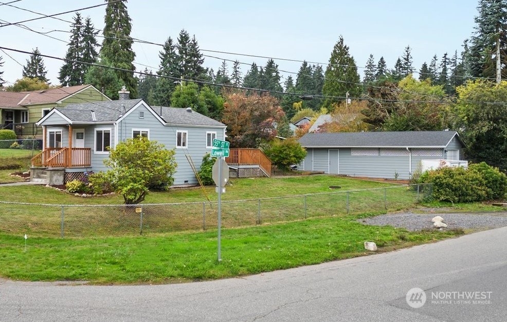 5514 Lowell Road Everett, WA 98203 - Photo 1 of 26 a front view of a house with a yard and garage