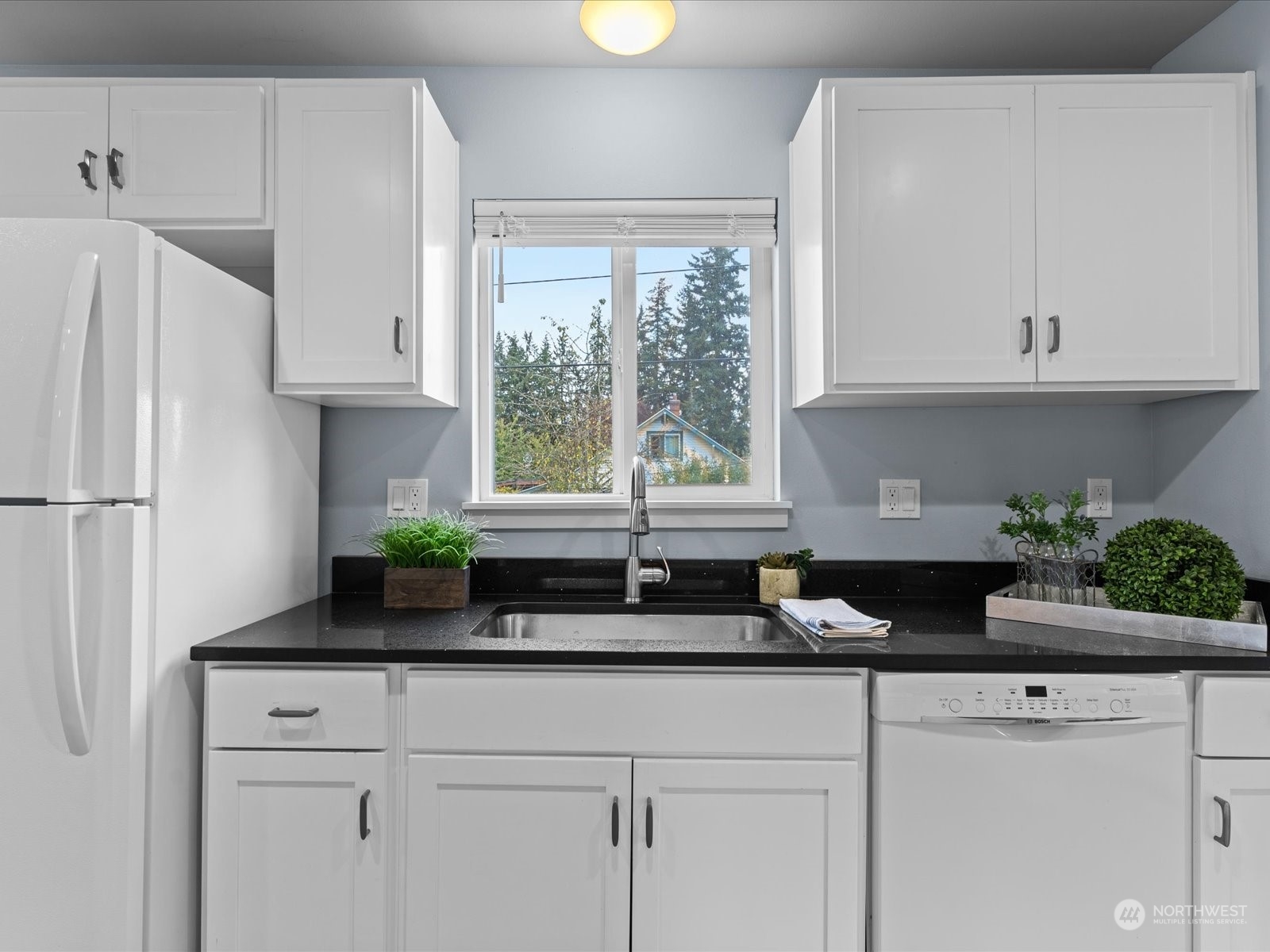 5514 Lowell Road Everett, WA 98203 - Photo 10 of 26 a kitchen with granite countertop white cabinets and a window