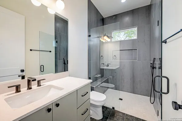 a bathroom with a sink toilet and shower