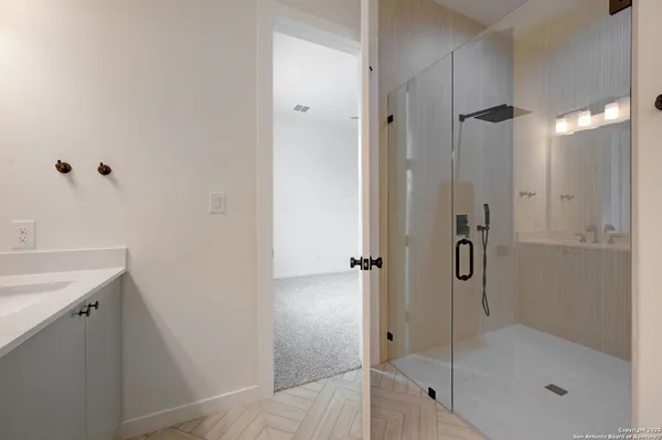 a bathroom with a shower and a sink