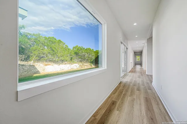 a view of a room with wooden floor and a window
