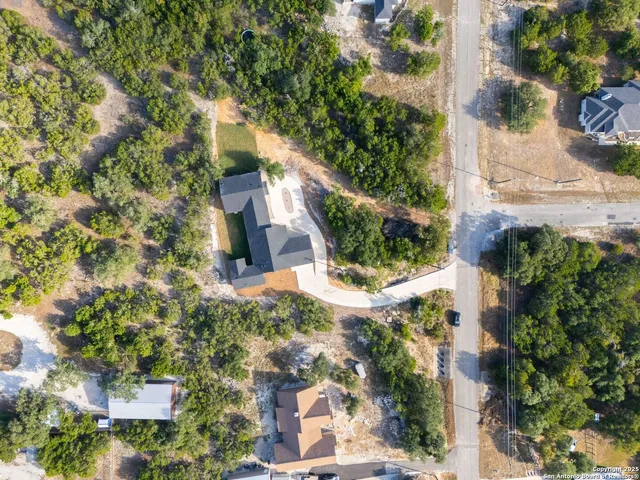 an aerial view of a house with a yard