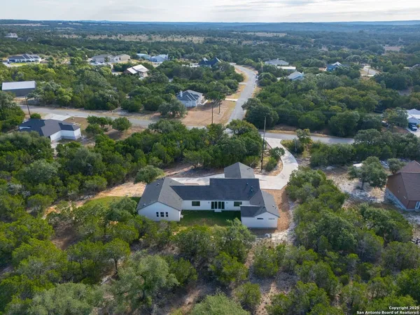 an aerial view of a house with yard and outdoor seating