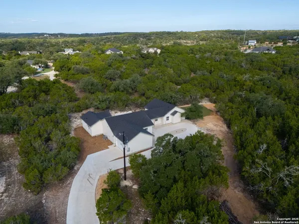 an aerial view of a house with yard