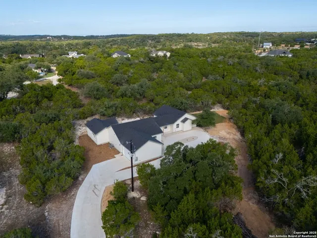 an aerial view of a house with yard