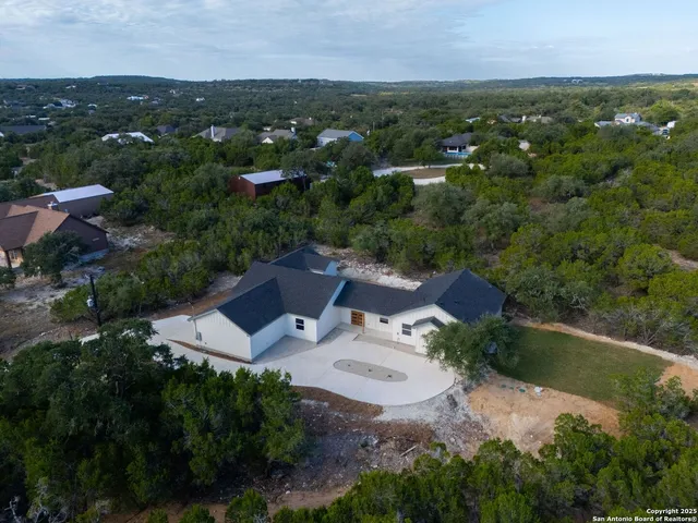 an aerial view of a house with outdoor space