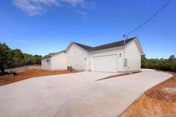 a view of a house with a yard and garage