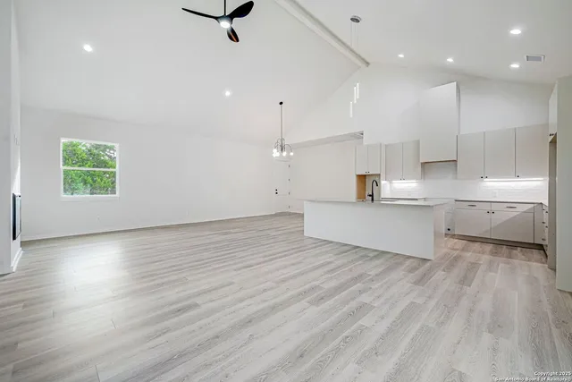 a view of a kitchen with wooden floor and a window