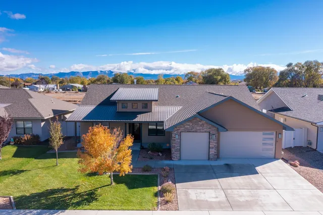 an aerial view of a house with a yard basket ball court and outdoor seating