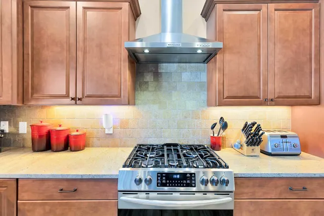 a kitchen with a stove and cabinets