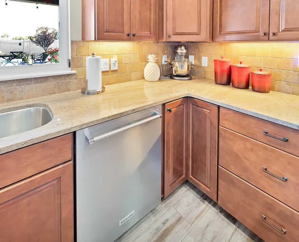a kitchen with granite countertop a sink and cabinets