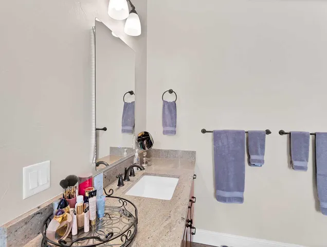 a bathroom with a bathtub sink and mirror