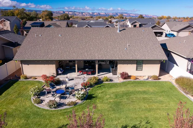 an aerial view of a house with swimming pool garden and patio