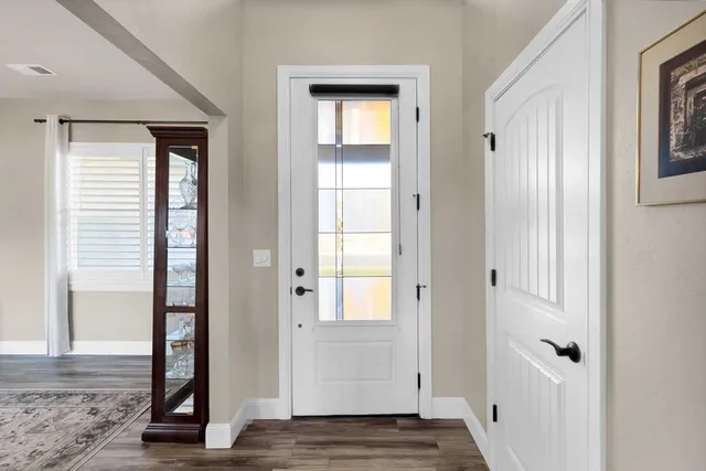 a view of an entryway with wooden floor