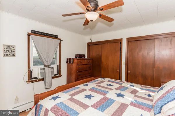 a living room with furniture flat screen tv and a window