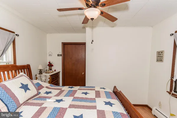 a living room with furniture a rug and a toilet