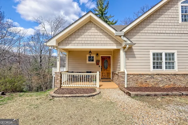 a view of a patio with table and chairs with wooden floor and fence