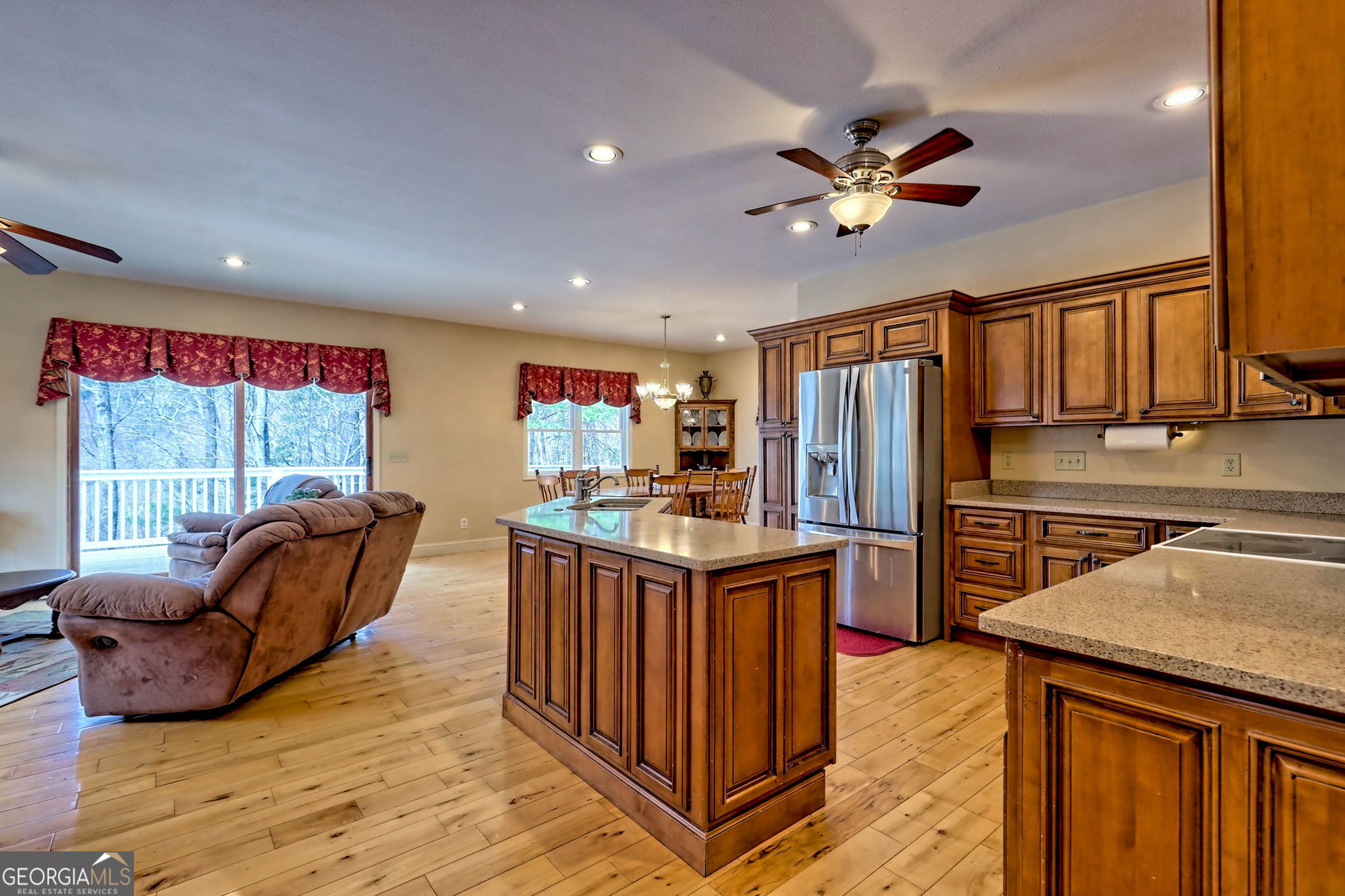 1068 Coleman River Road Clayton, GA 30525 - Photo 17 of 90 a kitchen with stainless steel appliances granite countertop a refrigerator a sink dishwasher a stove and white countertops with wooden floor