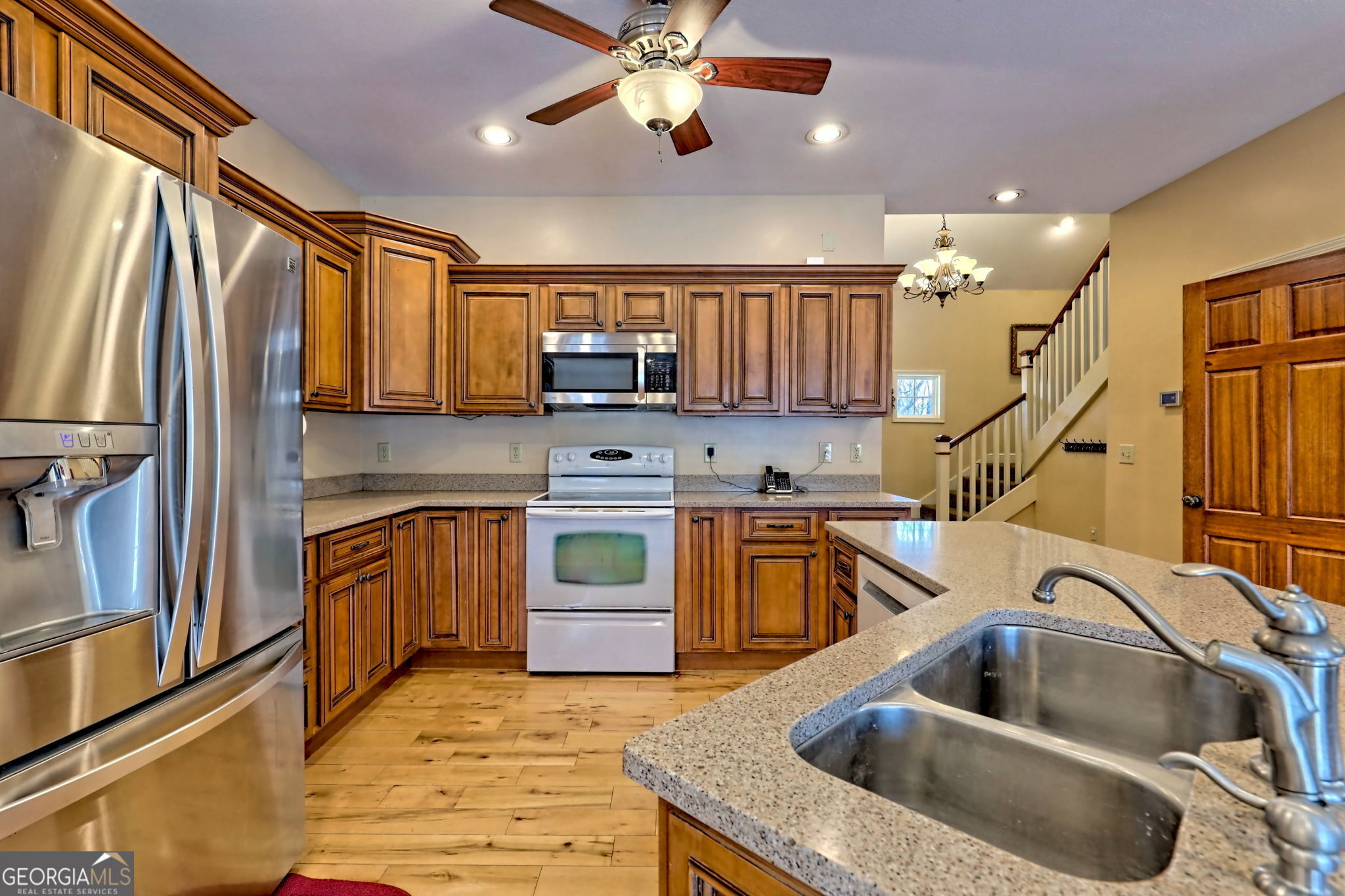 1068 Coleman River Road Clayton, GA 30525 - Photo 17 of 86 a kitchen with stainless steel appliances granite countertop a sink a stove and a refrigerator