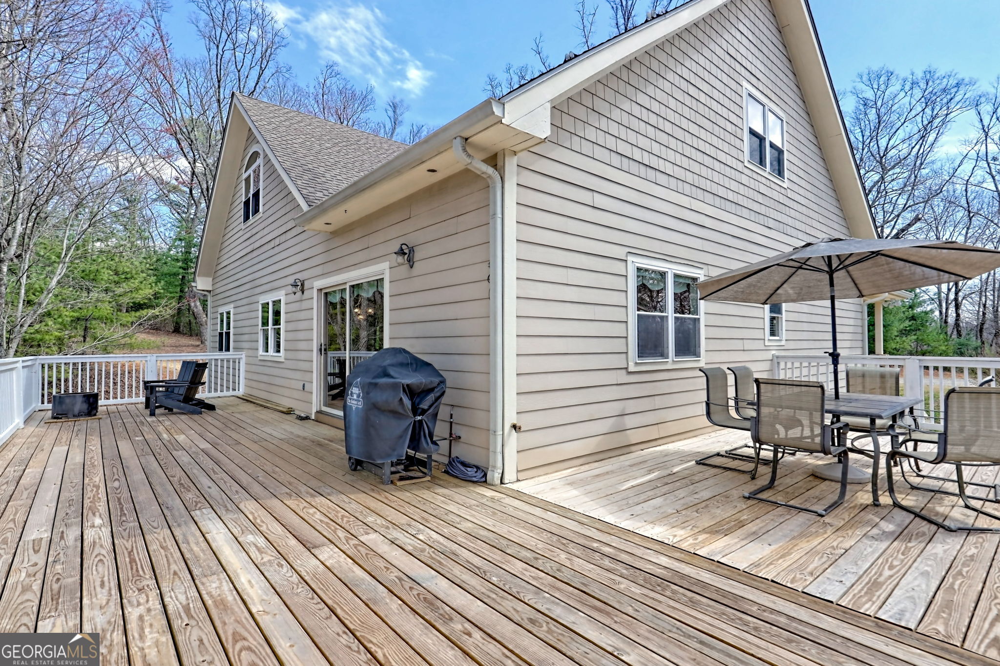 1068 Coleman River Road Clayton, GA 30525 - Photo 23 of 86 a view of a patio with table and chairs with wooden floor and fence
