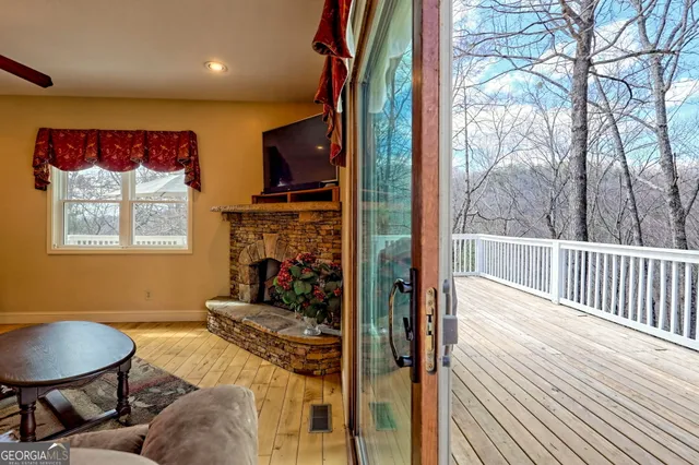 a living room with furniture a flat screen tv and a window