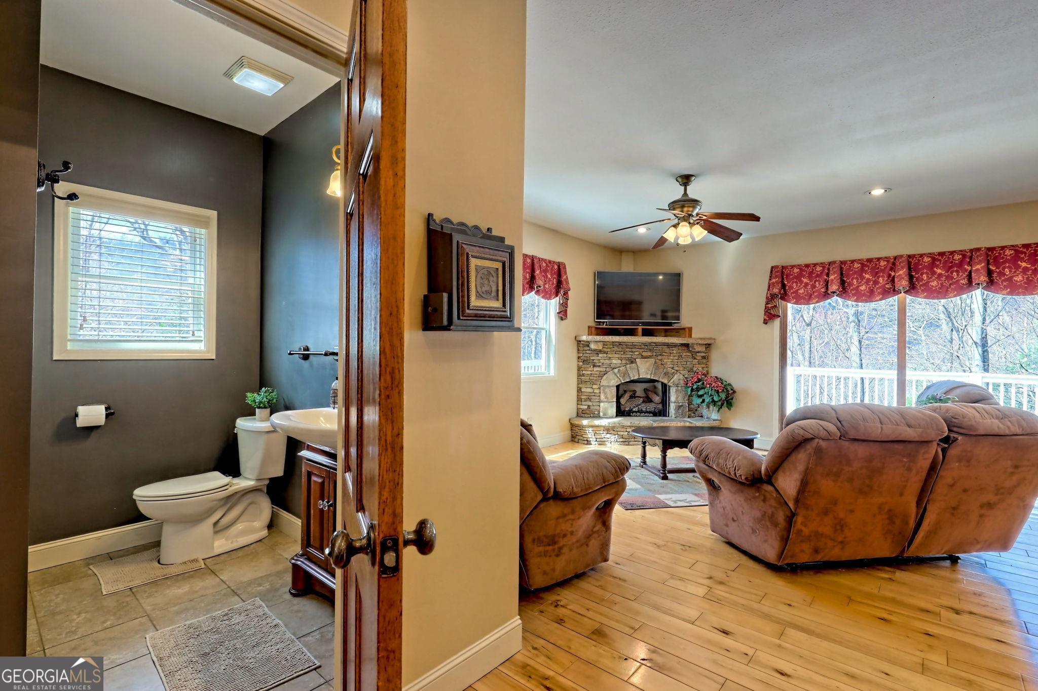 1068 Coleman River Road Clayton, GA 30525 - Photo 38 of 86 a living room with furniture a flat screen tv and a window