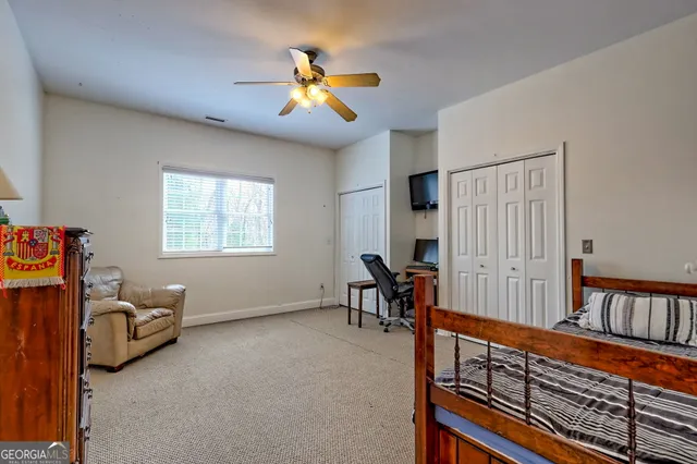 a view of a house with a yard covered in snow