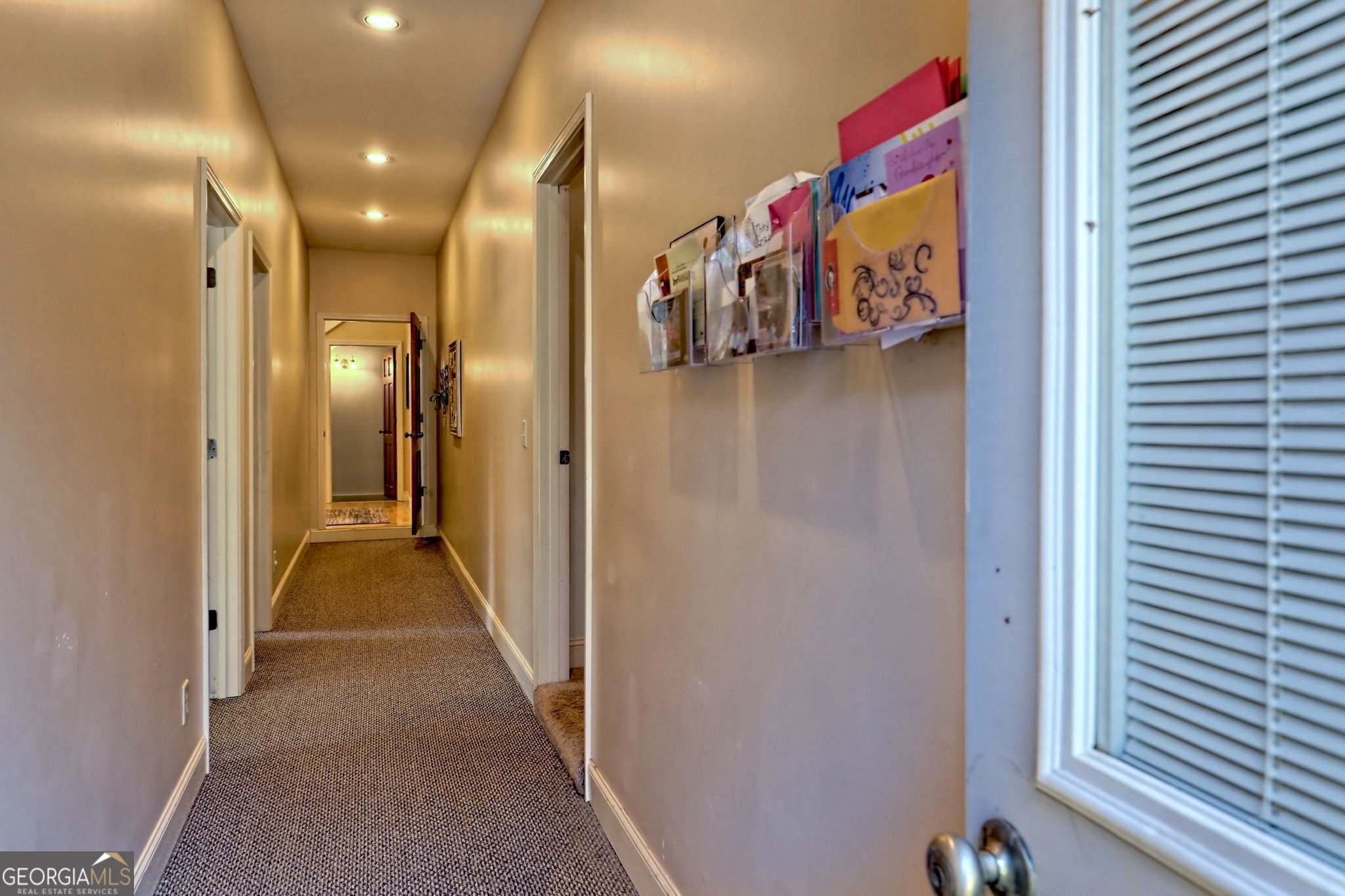 1068 Coleman River Road Clayton, GA 30525 - Photo 44 of 86 a view of a hallway with a dining table and a chandelier