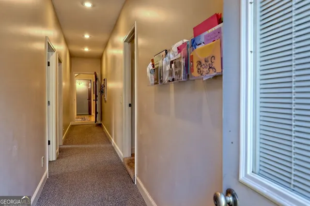 an aerial view of green landscape with trees houses and mountain view