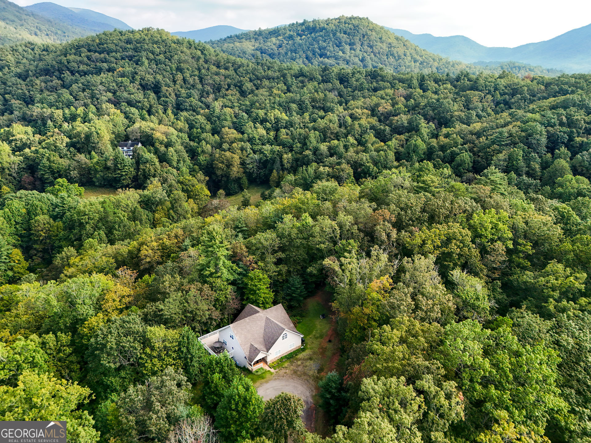 1068 Coleman River Road Clayton, GA 30525 - Photo 5 of 86 an aerial view of a house with a lush green forest