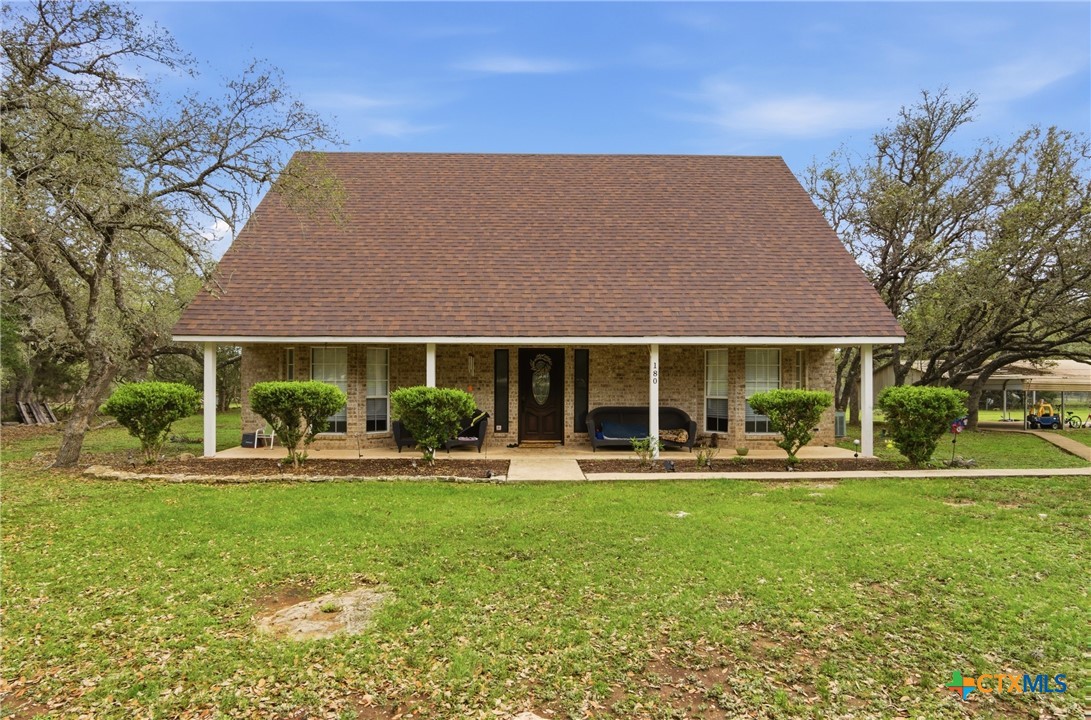 642 Phantom Rider Trail Spring Branch, TX 78070 - Photo 33 of 41 a front view of a house with a yard patio and fire pit