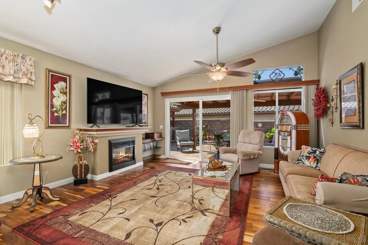 2516 Columbine Road Alpine, CA 91901 - Photo 12 of 33 a living room with furniture a flat screen tv and a floor to ceiling window