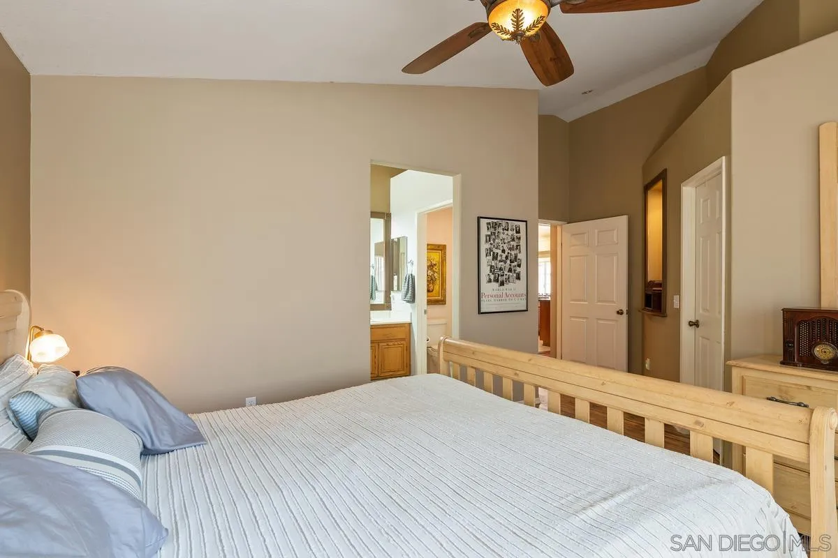 2516 Columbine Road Alpine, CA 91901 - Photo 19 of 33 a bedroom with a bed and a chandelier