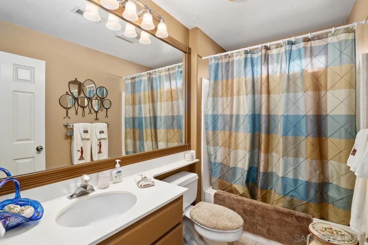 2516 Columbine Road Alpine, CA 91901 - Photo 23 of 33 a bathroom with a sink a toilet and shower curtain