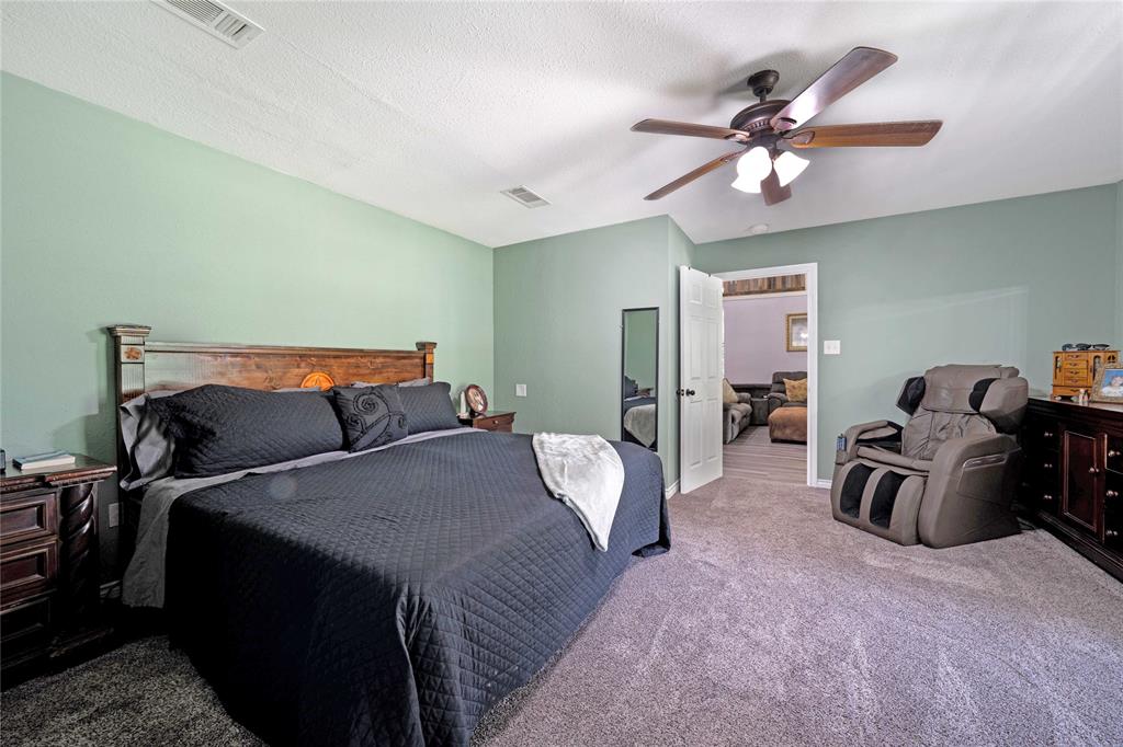 1511 North Walnut Grove Road Midlothian, TX 76065 - Photo 17 of 39 a bed room with a bed and a ceiling fan